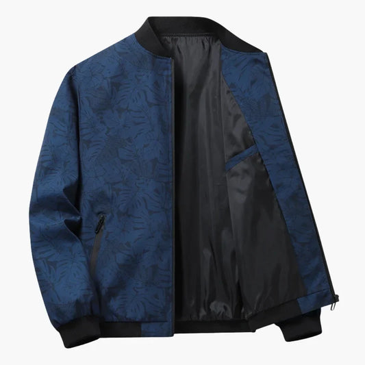 Blouson bomber bleu à imprimé feuilles, doublure noire, fermeture zippée, poignets côtelés.