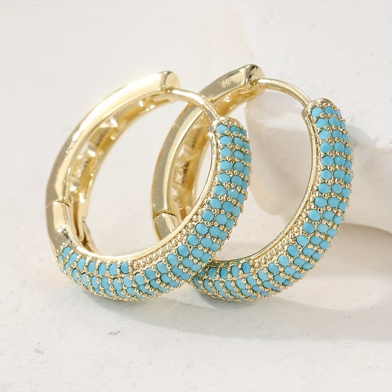 Créoles dorées à perles turquoise, motif en bordure
