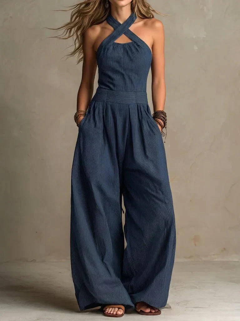 Combinaison pantalon bleu marine à encolure croisée, bretelles croisées et jambes amples