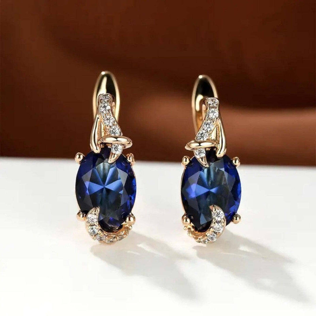 Boucles d’oreilles pendantes dorées, goutte bleue nuit sertie de pierres blanches