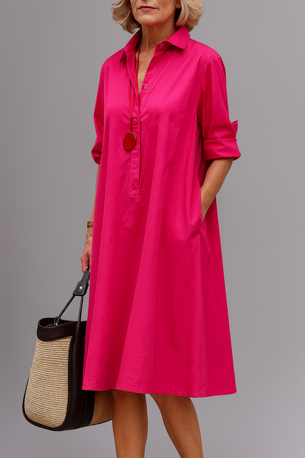 Robe midi rose soignée, col chemise, manches trois-quarts, boutonnage devant.