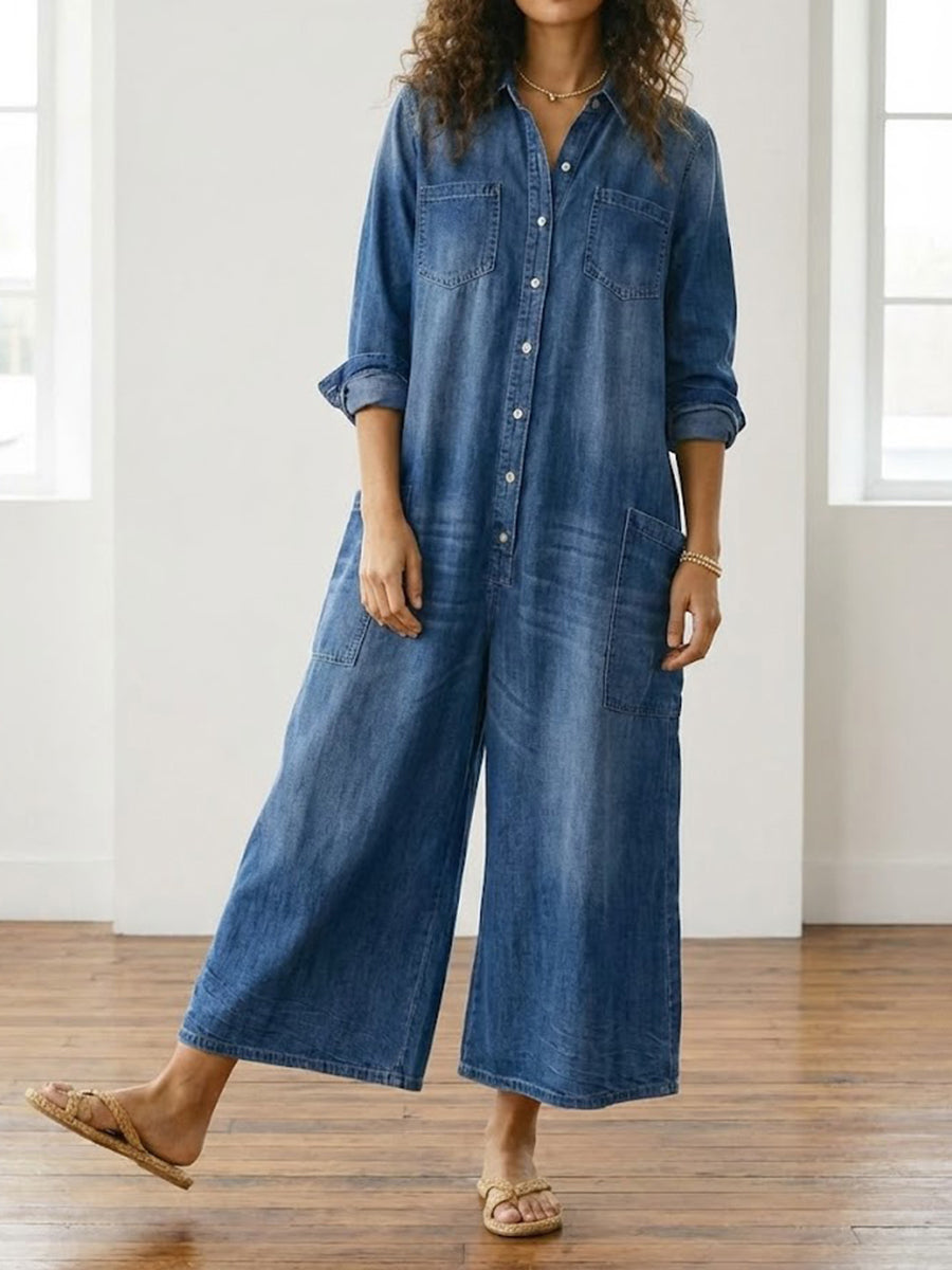 Salopette longue en denim bleu vintage, rangée de boutons, poches poitrine, jambes larges.