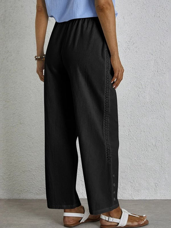 Pantalon ample noir avec taille élastique et cordon, boutons décoratifs latéraux