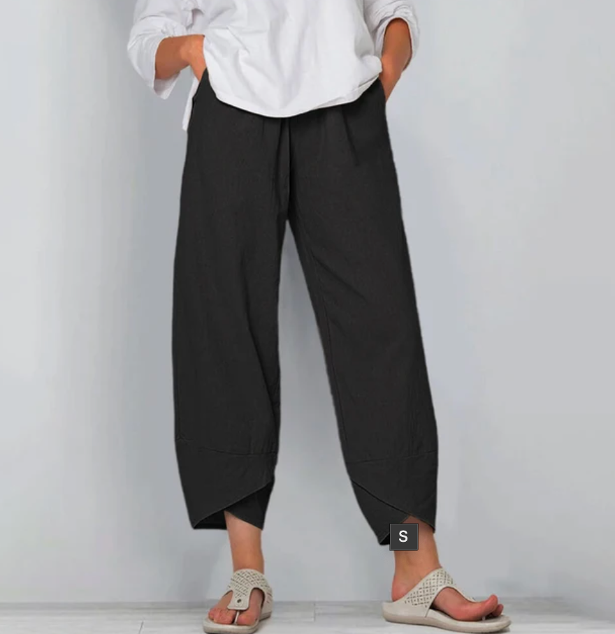 Pantalon léger noir à taille élastique, jambe ample, bas asymétrique.