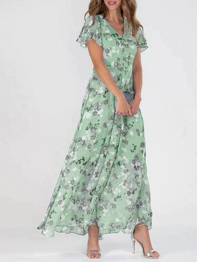 Robe fluide à fleurs vert menthe, manches courtes volantées, encolure en V.