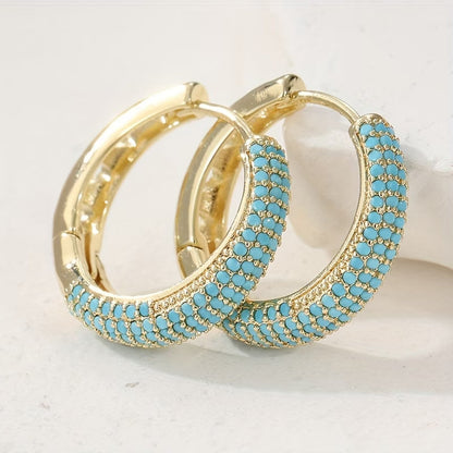 Créoles dorées à perles turquoise, motif en bordure