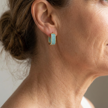 Créoles turquoise dans l’oreille, anneaux dorés à pavé de pierres turquoise