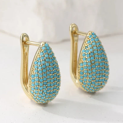 Boucles d’oreilles larme turquoise, monture dorée, pavées de petits strass