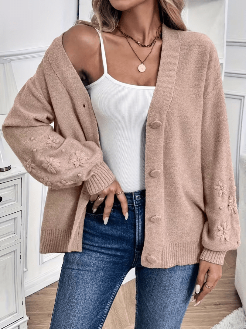 Gilet beige à col V, manches fleuries, boutons devant, coupe ample sur jean.
