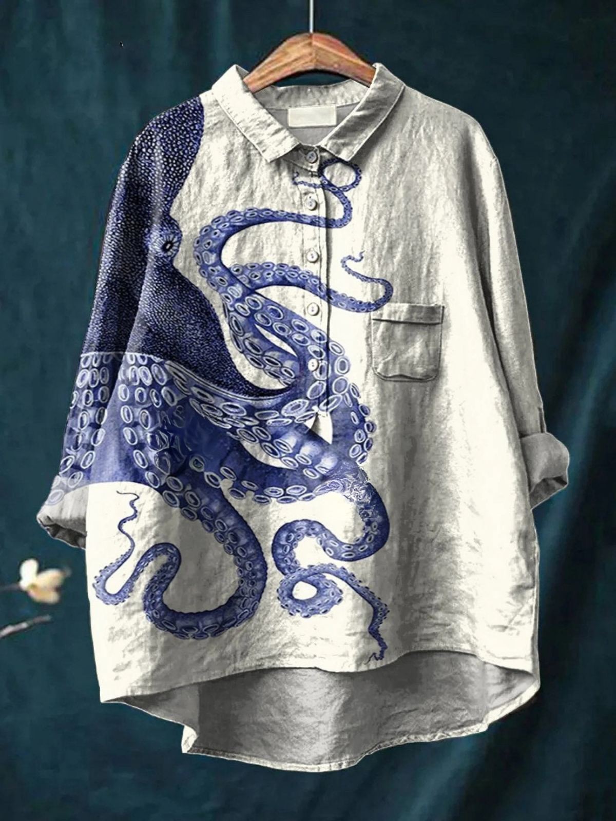 T-shirt léger gris clair imprimé tentacules bleu, encolure boutonnée, manches longues.