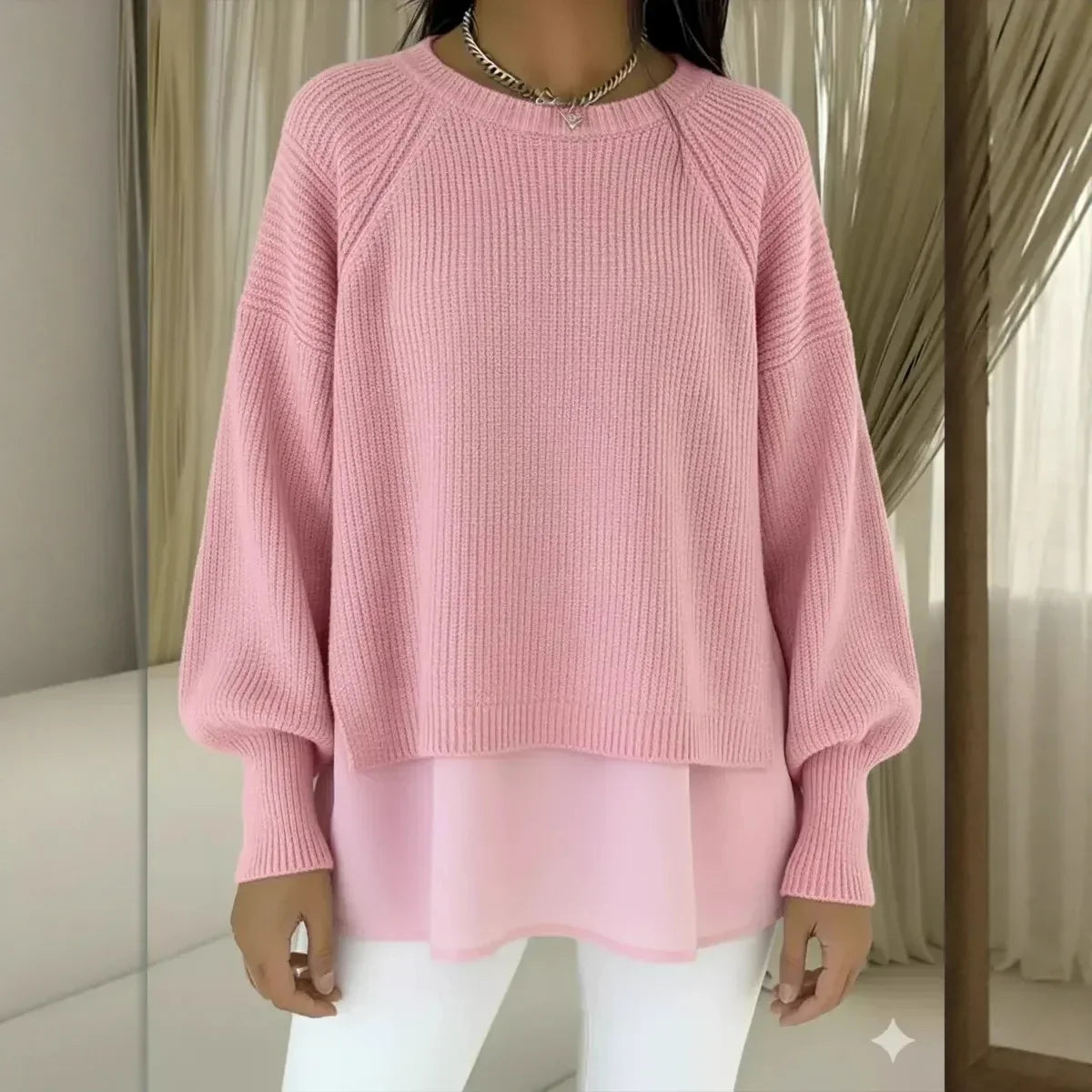 Pull en tricot rose, col rond côtelé, manches bouffantes, bas superposé