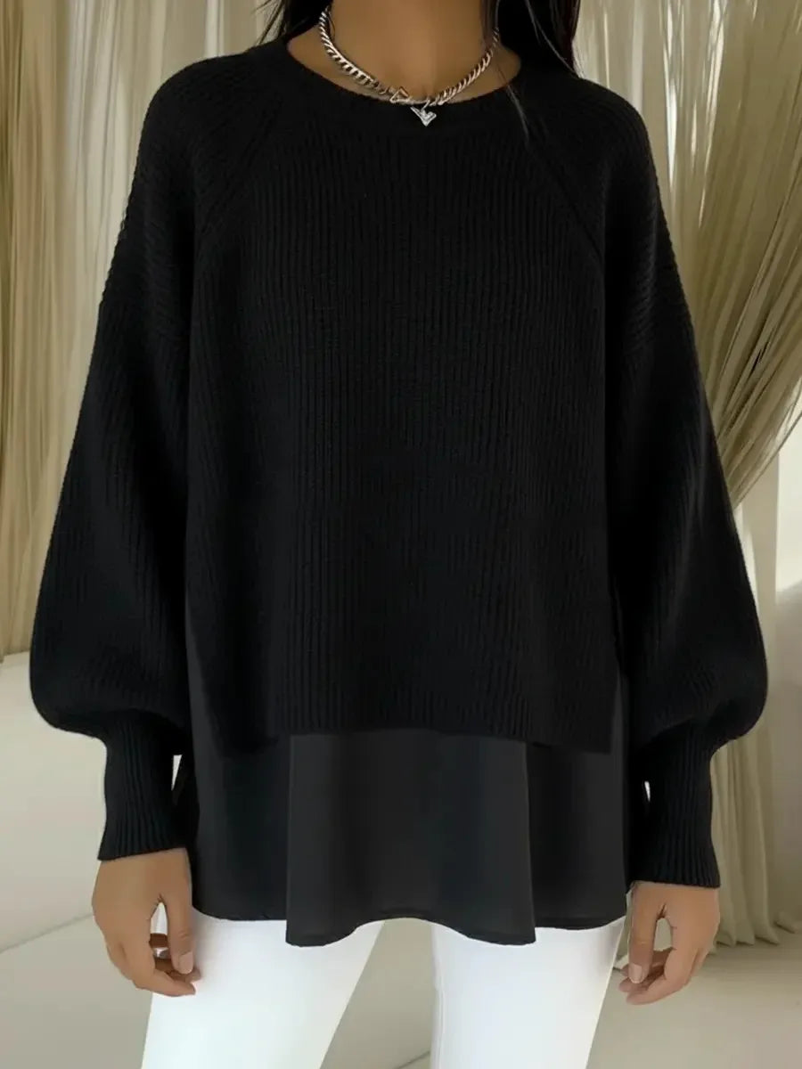 Pull en tricot noir, col rond côtelé, manches bouffantes, bas superposé