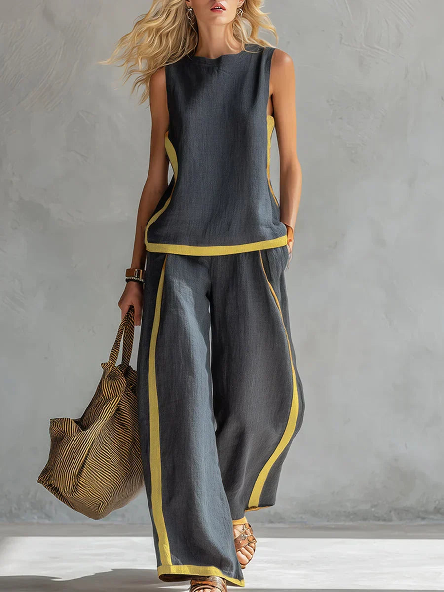 Ensemble gilet sans manches et pantalon long gris foncé, finitions dorées bicolores.