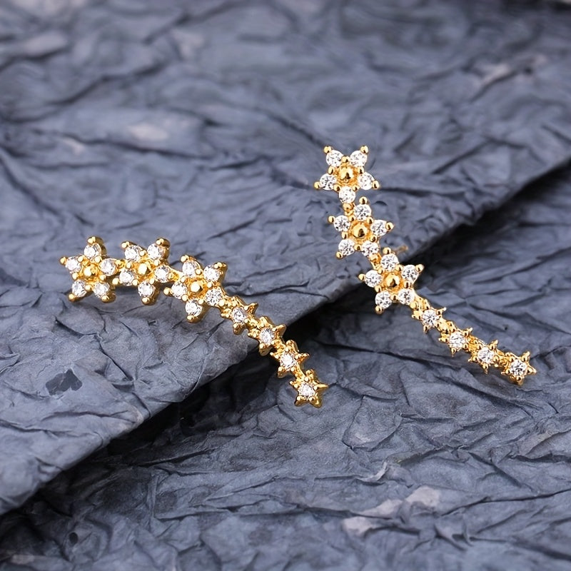 Boucles d’oreilles fleurs en strass doré, longues, motif floral en grappe.