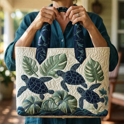 Sac cabas en tissu ivoire, broderie tropicale (feuilles, tortues) et anses bleu marine.