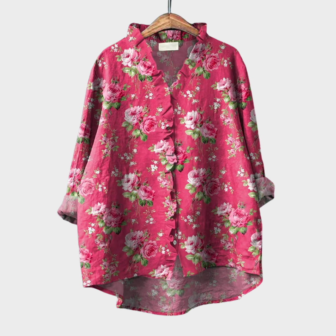 Blouse rose à fleurs, manches longues, col en V, boutonnage devant, tissu léger.