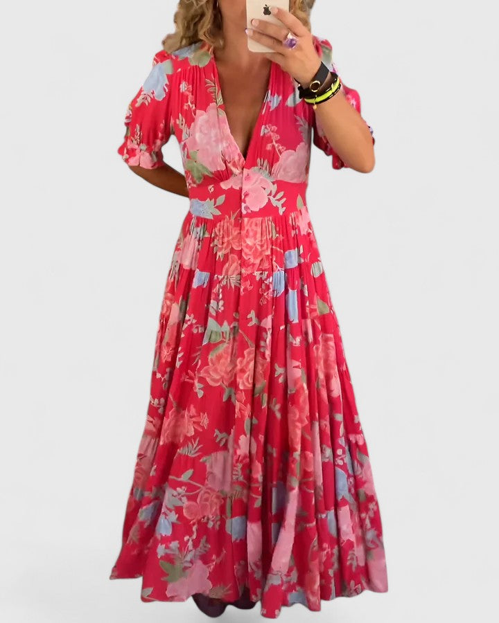 Robe longue rouge fleurie, col V, manches bouffantes, jupe plissée à volants