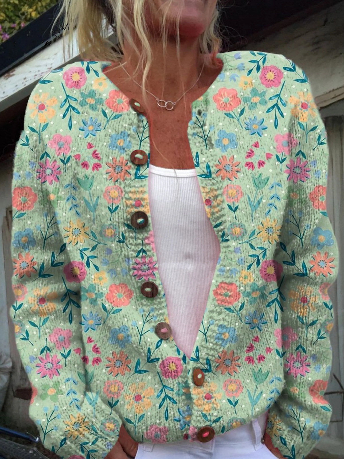 Gilet fleuri vintage à manches longues turquoise, fermeture boutonnée marron.