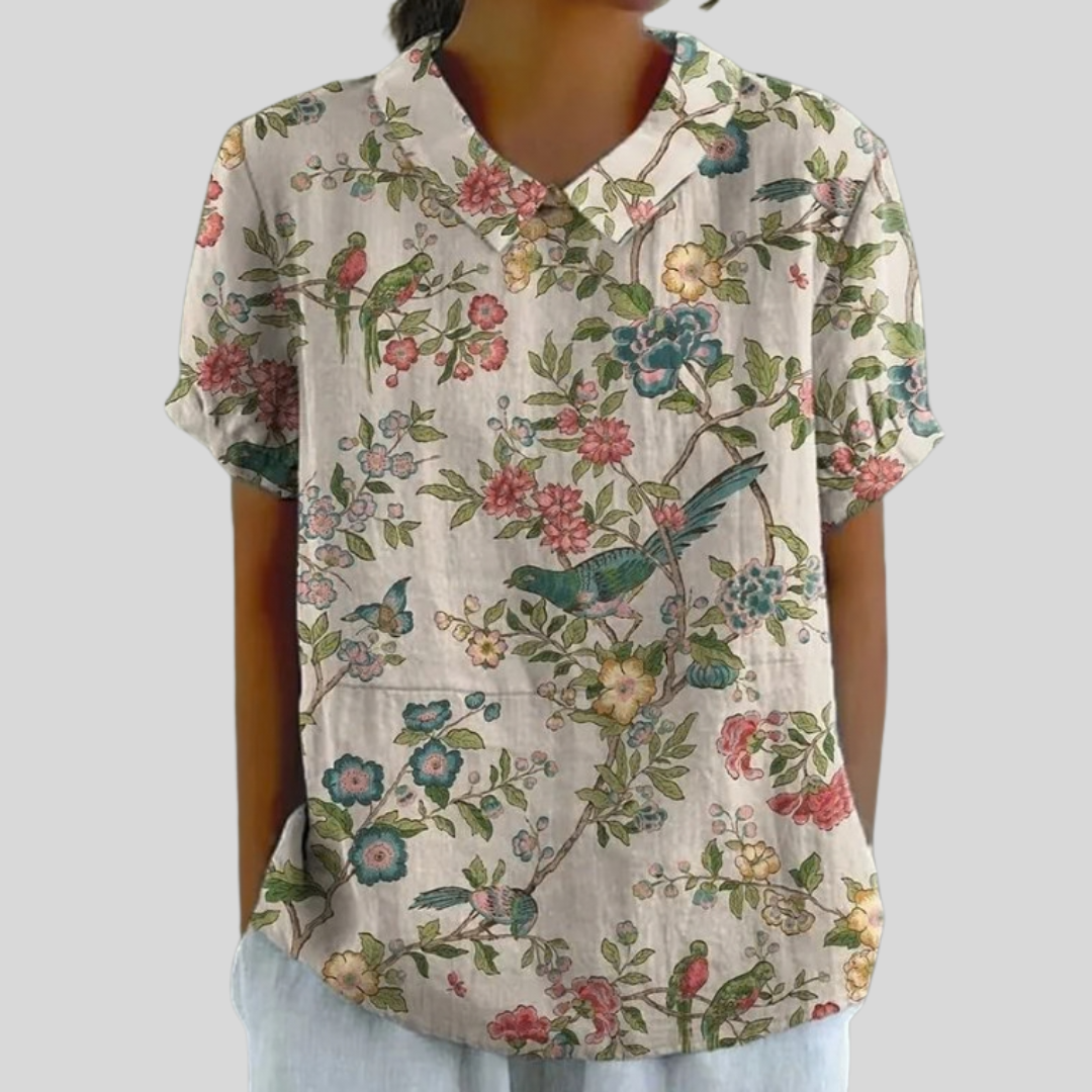 Blouse manches courtes à col en V, fond clair, imprimé floral illustré multicolore.