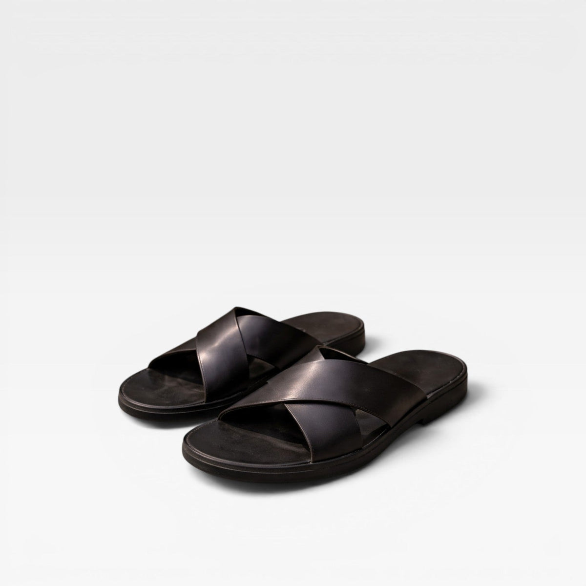 Sandales en cuir noires à brides croisées, mule à enfiler.