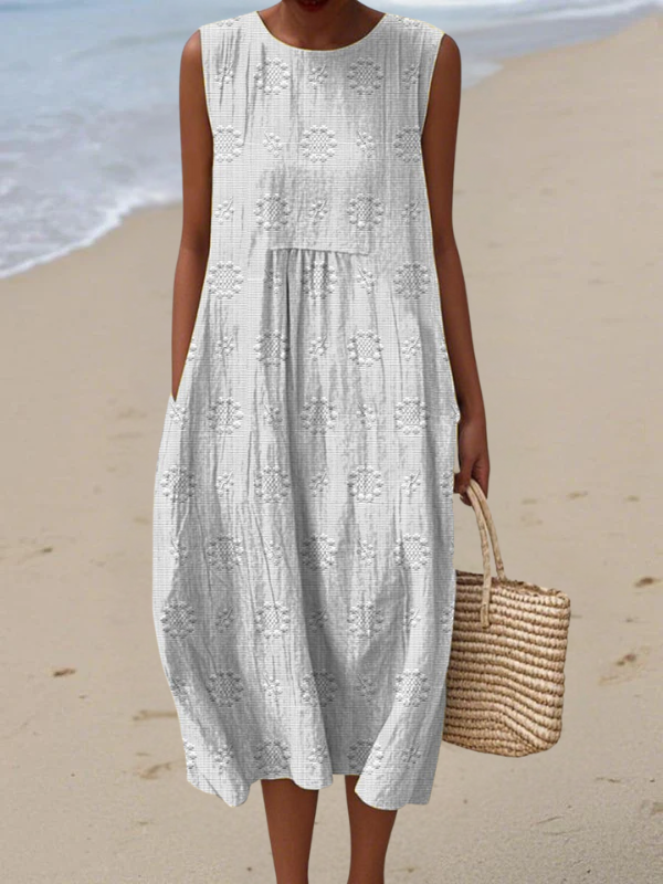 Robe midi blanche sans manches broderie florale, volantée et évasée