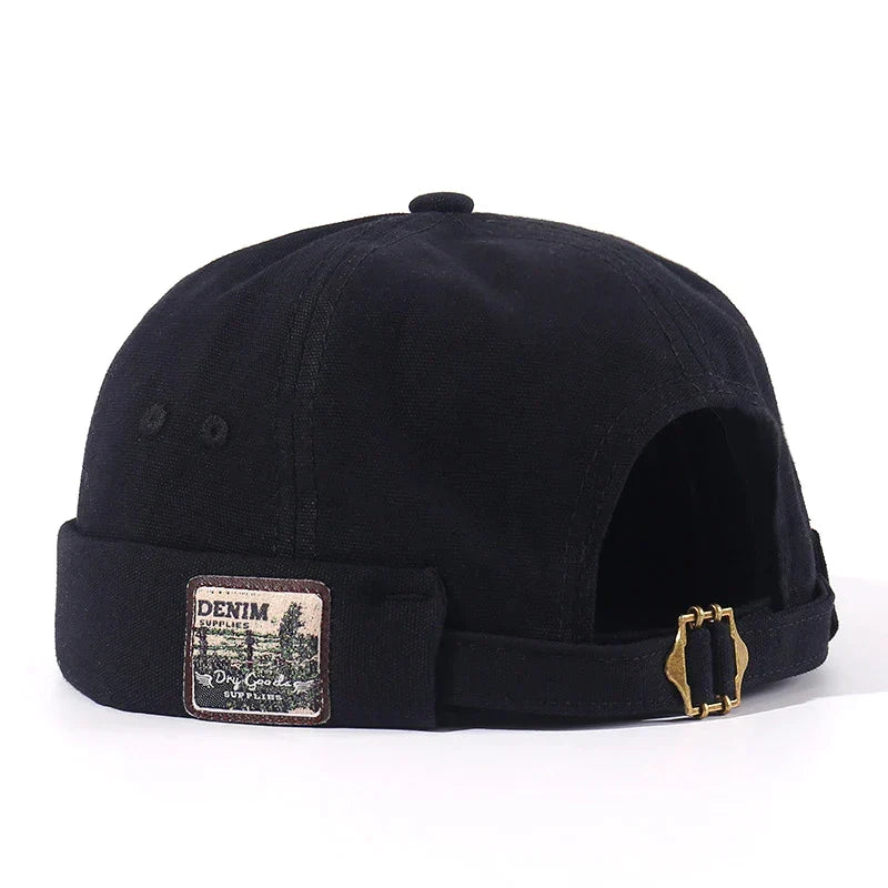 Casquette pour animal de compagnie en tissu noir, patch « Denim », sangle et boucle.