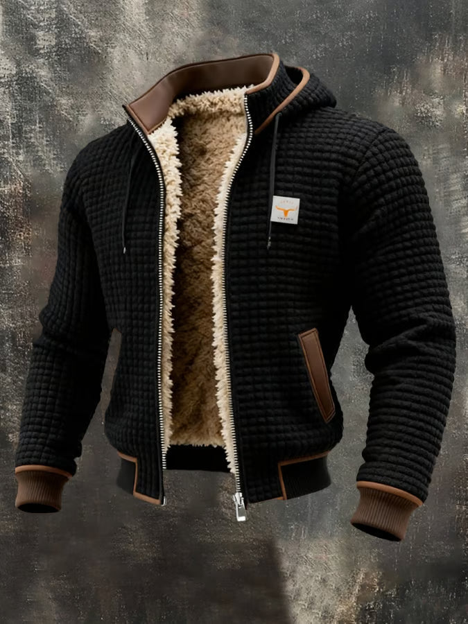 Veste bomber homme noire à capuche, doublure sherpa chaude, texture gaufrée.