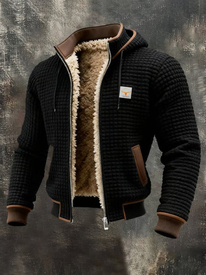Veste bomber homme noire à capuche, doublure sherpa chaude, texture gaufrée.